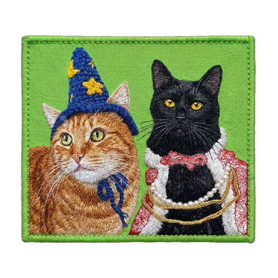 Embroidered portrait patch of two cats — an orange tabby in a wizard hat and a black cat in a royal cape with pearls